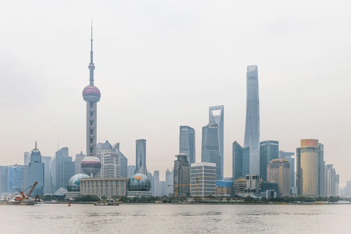Shanghai’s Pudong skyline, including the Oriental Pearl Tower and Shanghai Tower, across the Huangpu River.